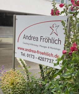 Praxisschild mit dem Logo der Praxis: über dem Namen Andrea Fröhlich ist ein von links unten nach rechts gehender dunkelroter Bogen, in welchem eine springende Figur zu sehen ist.